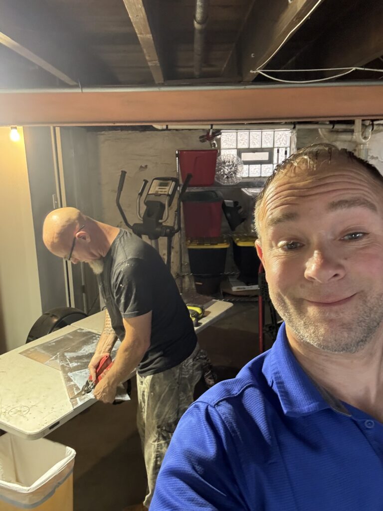 Liberty Heating Cooling and Plumbing team on a service call in a St. Louis basement