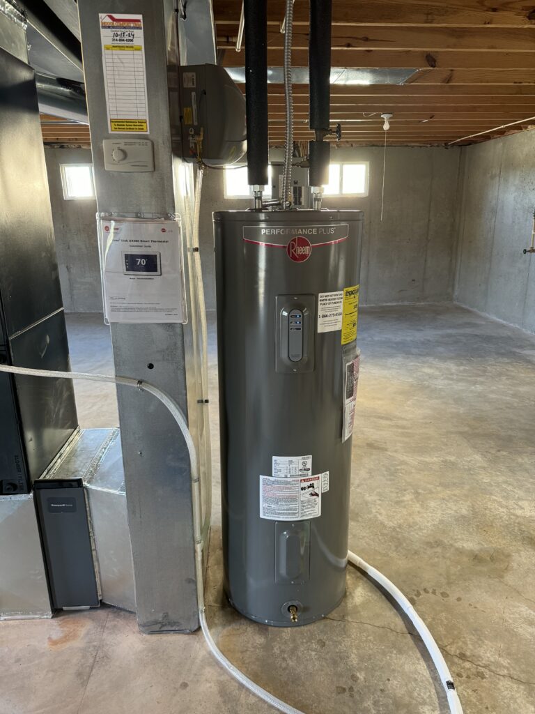 New electric tank water heater installed in an unfinished basement in South St. Louis County